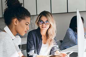 Two ladies working on computer