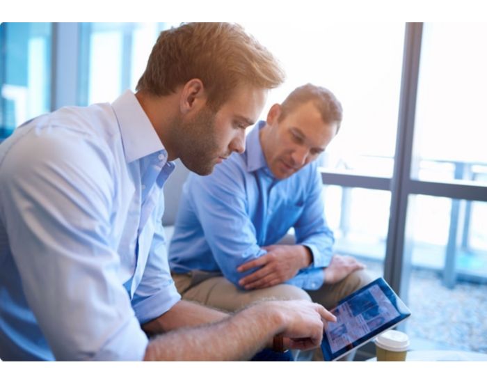 Two people looking at tablet