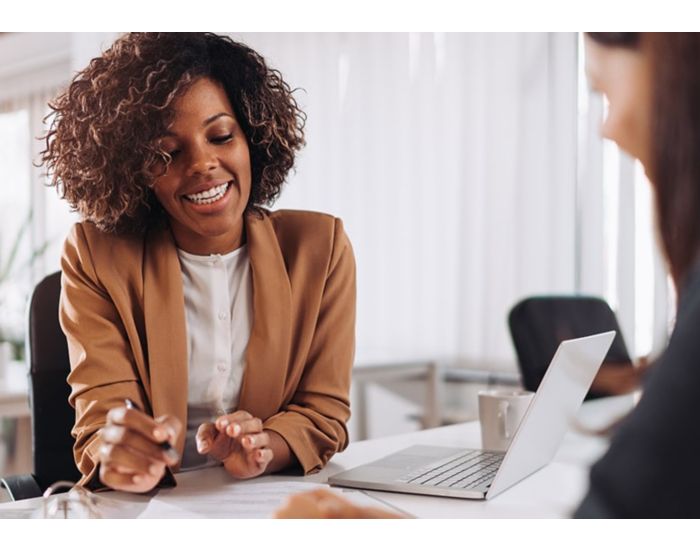 Two ladies discussing over finance